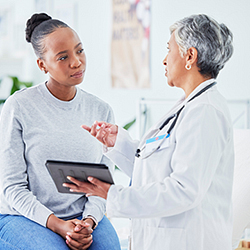 a woman discussing uterine fibroids with her doctor