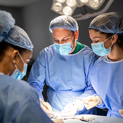 three surgeons performing cardiac bypass surgery