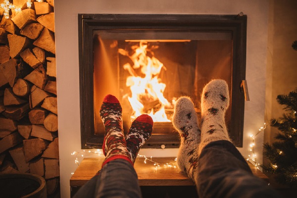 feet in socks by a winter fire