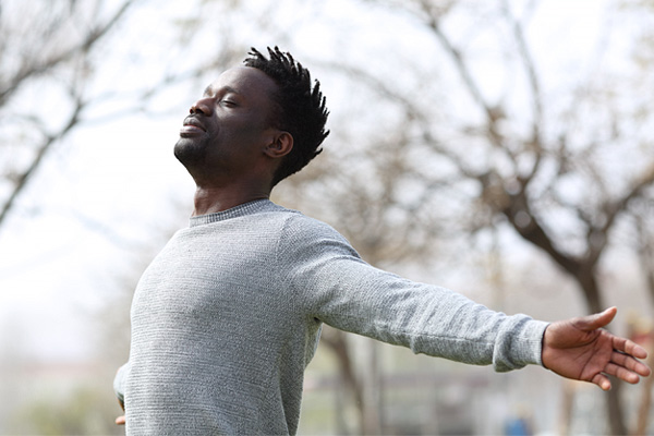 a man with outstretched arms and chest pushed forward