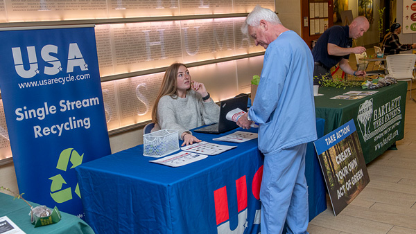 Baystate Health employee learns about single stream recycling at a booth