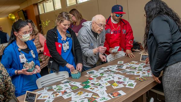 Event attendees looking at seed packets on a table
