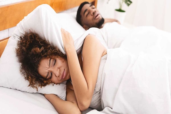 snoring partner keeping woman awake