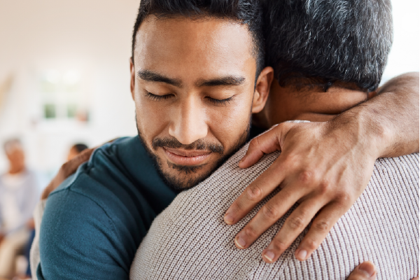 Young African American man hugging his elderly father