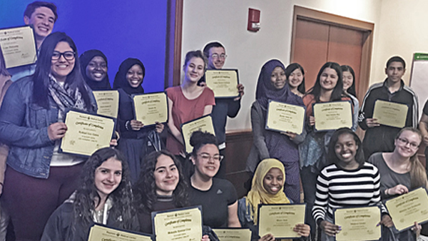 Posed group photo of BSEP students holding credentials