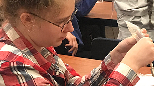 Candid image of a BSEP student working with an IV bag