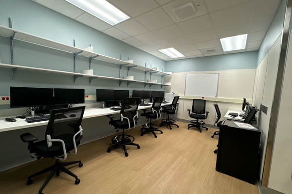 small room with 4 computers and chairs