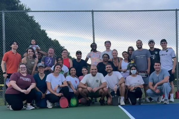 a large group of internal medicine residents at a pickle ball court