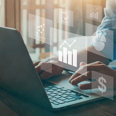 person sitting at a laptop with transparent icons of different benefits floating around