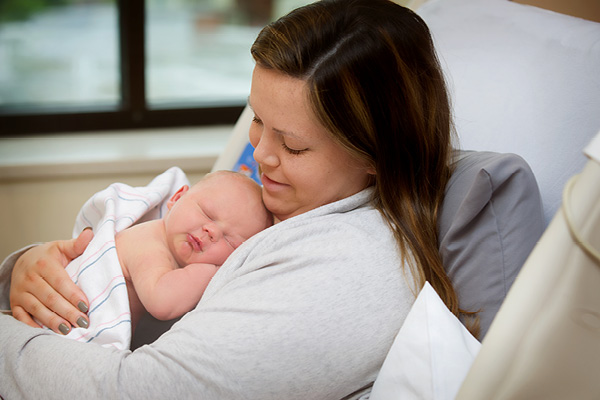 newborn child resting in a mothers arms