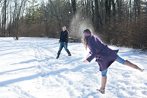 Young adults having a snow ball fight