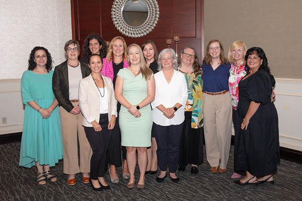 a large group of women at the bwims impact award ceremony