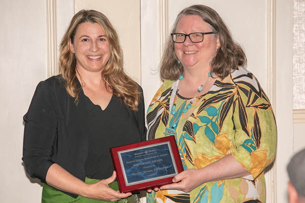 two women holding the bwims impact award