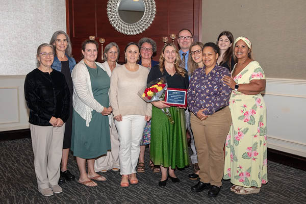 a large group of women at the bwims impact award ceremony