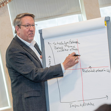 presenter standing in front of a graph