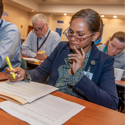 professional highlighting paperwork during a presentation