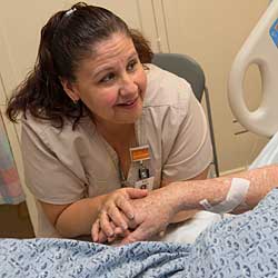 Caregiver holding a patient's hand