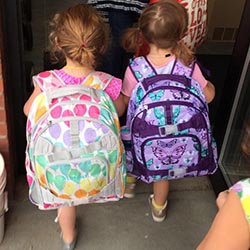 two children with backpacks on