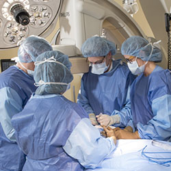 4 surgeons in an operating room preforming surgery