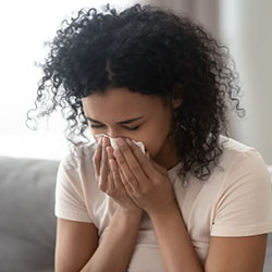 woman blowing her nose