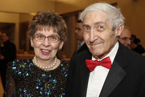 two older people posing for a photo, one of them vinick