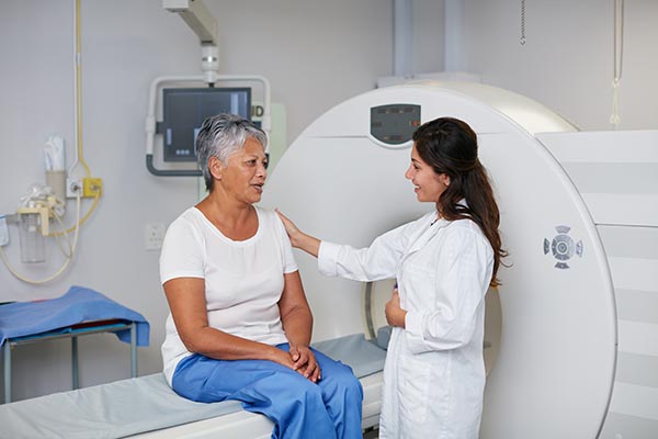 a woman discussing pancreatic cysts with her doctor, waiting for an MRI scan
