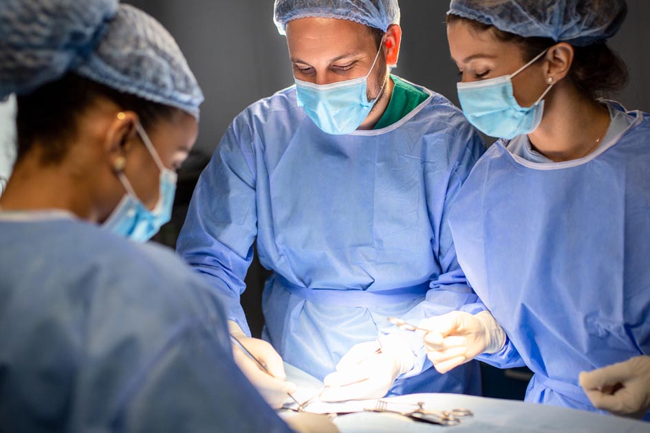 surgeons in operating room performing heart bypass surgery