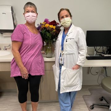 Karen giving flowers to Dr. Wanamaker
