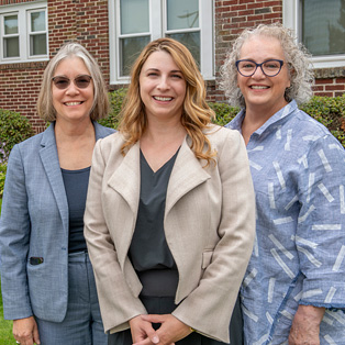 Heather Sanky, Burkman Endowed Chair of Obstetrics & Gynecology, Division of Midwifery Director Autumn Versace, and Former Director of Midwifery Susan DeJoy outside the Midwifery House in Springfield.
