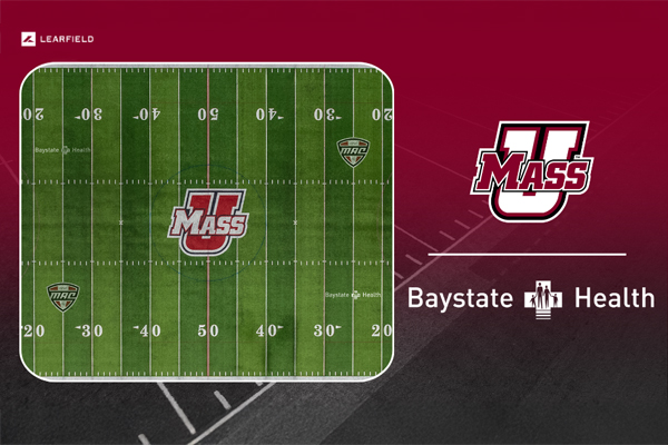a picture of the UMass football field with the baystate health logo imprinted on the field