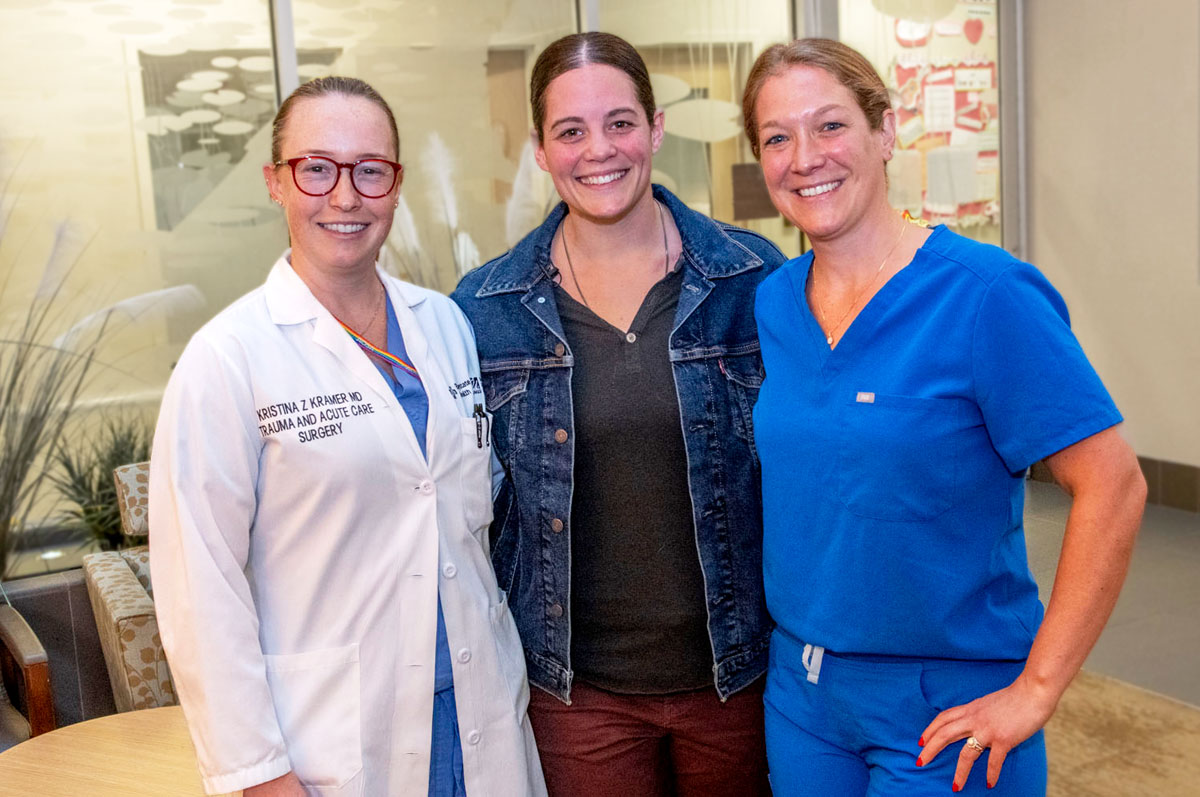 trauma surgeon and trauma nurse with their trauma survivor patient