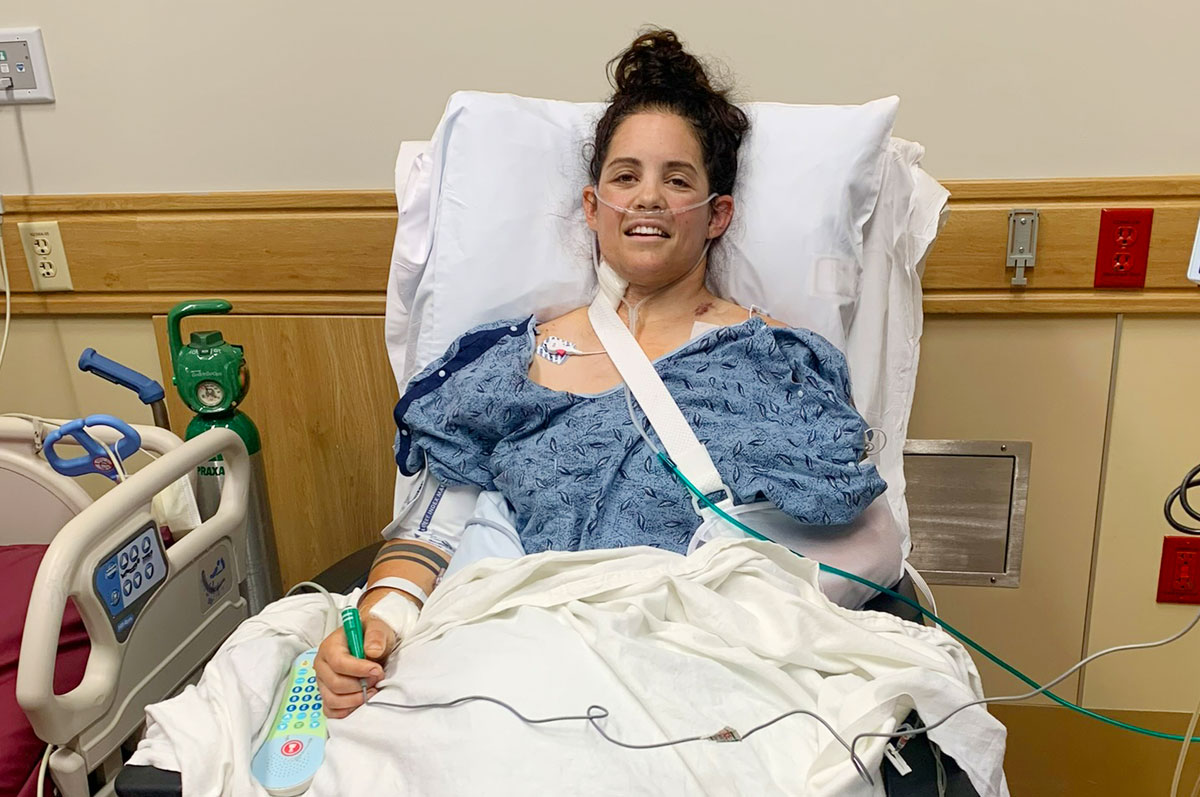 a trauma survivor sitting up in a hospital bed