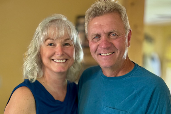 a husband and wife smiling side by side