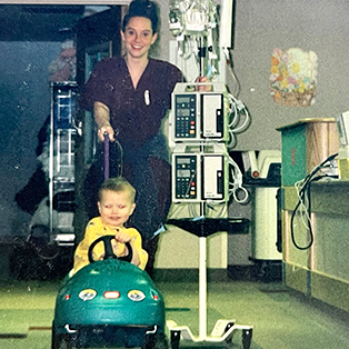 Max Preston drives a car around the halls of Baystate Children's Hospital with a child-life specialist while receiving cancer care.