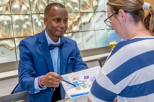 baystate concierge pointing to hospital map directions helping a visitor