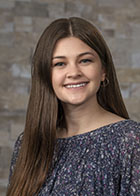 Formal portrait of a smiling Avery Allen