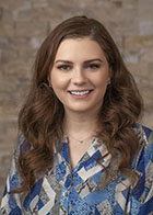 Formal portrait of a smiling Dr Nakiya Belford