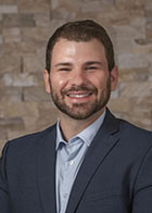 Formal portrait of a smiling Dr Joseph Douglass