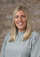 Formal portrait of a smiling Dr Jordan Eichelser