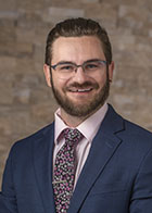 Formal portrait of a smiling Dr Calvin Knox