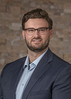 Formal portrait of a smiling Dr Jacob Paul