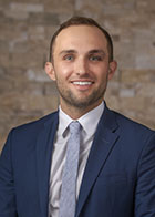 Formal portrait of a smiling Dr Kit Sitterley