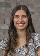 Formal portrait of smiling Dr Claudia Heritage