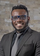 Formal portrait of Osuji Vitalis wearing a suit