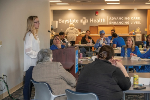 a nurse giving a grand rounds presentation
