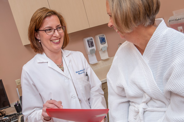 breast surgeon dr. holly mason discussing a chart with a patient