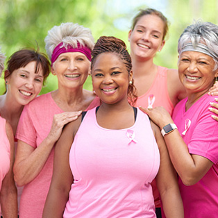 a group of women wearing pink for breast cancer awareness
