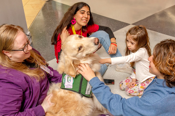 facility dog Isa and her handler greeting kids