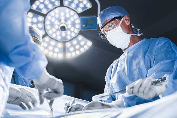 neurosurgeon performing the jannetta procedure in an operating room