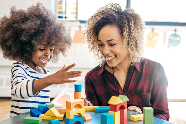 parent and toddler playing with blocks